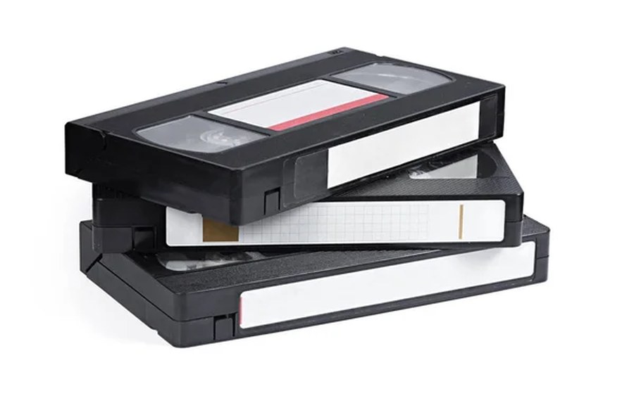 A stack of old VHS cassettes waiting to be transferred to digital files at Galvitech in Paarl